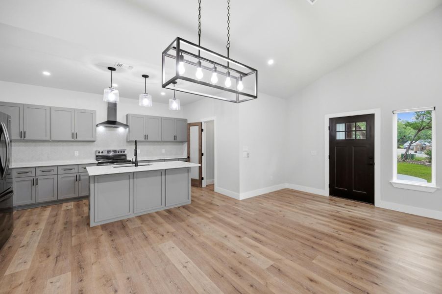 Bright, open-concept kitchen and living area with vaulted ceilings. Bright, open-concept kitchen and living area with vaulted ceilings.