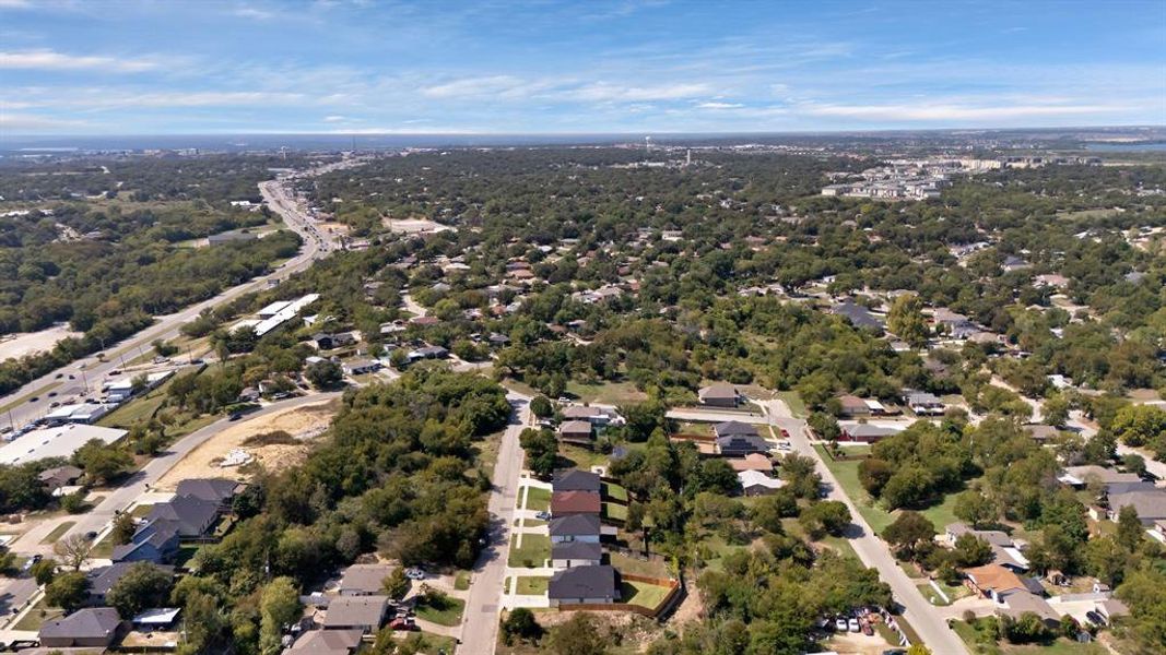 Aerial perspective of suburban area featuring a tree filled landscape Aerial perspective of suburban area featuring a tree filled landscape