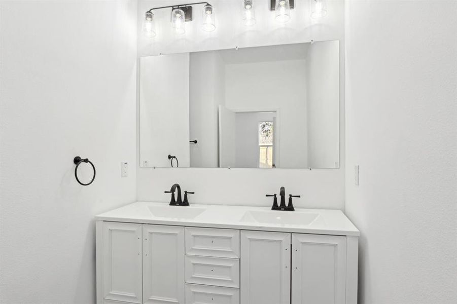 Bathroom featuring double vanity and a sink