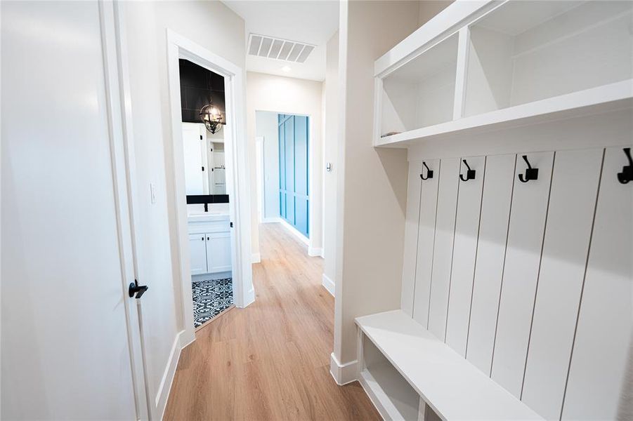 Mudroom featuring light wood-type flooring and baseboards