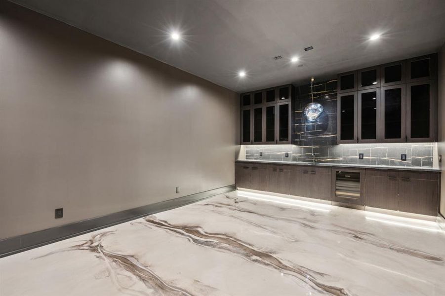 Basement Media room with ice machine, beverage refridgerator, built in shelving and cabinetry Basement Media room with ice machine, beverage refridgerator, built in shelving and cabinetry