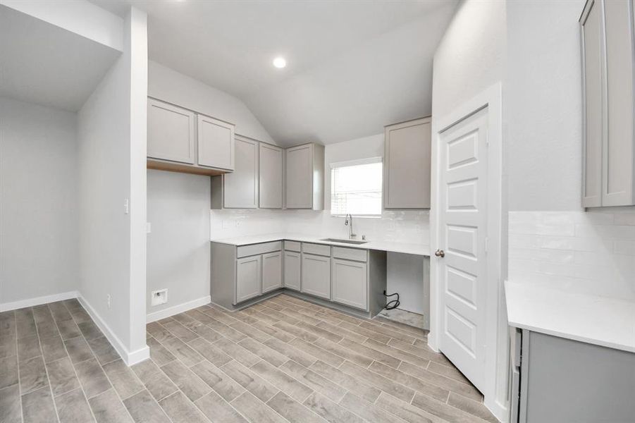 Discover another perspective of this stunning kitchen, generously appointed with an abundance of counter space.