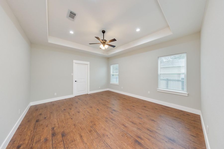 Spacious primary bedroom with ample natural light, a walk-in closet, and a serene atmosphere for ultimate relaxation. Spacious primary bedroom with ample natural light, a walk-in closet, and a serene atmosphere for ultimate relaxation.