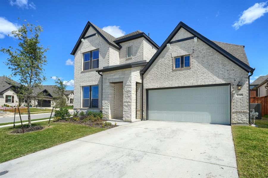 Front exterior of a new home in , Fate, TX, highlighting curb appeal (Image 2). Front exterior of a new home in , Fate, TX, highlighting curb appeal (Image 2).