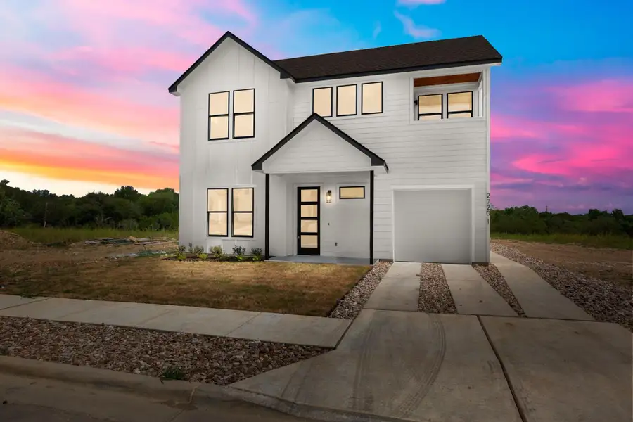 Modern farmhouse style home featuring driveway, board and batten siding, an attached garage, roof with shingles, and a front lawn