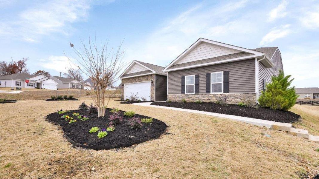 Front exterior of a new home in Sweet Briar, Ooltewah, TN, highlighting curb appeal (Image 23). Front exterior of a new home in Sweet Briar, Ooltewah, TN, highlighting curb appeal (Image 23).
