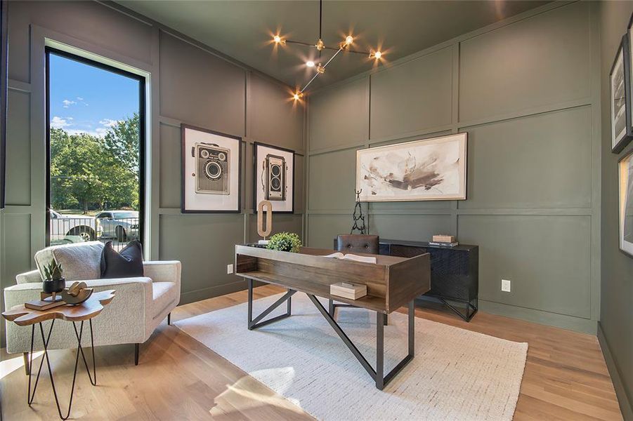 Home office featuring a decorative wall, wood finished floors, and a chandelier