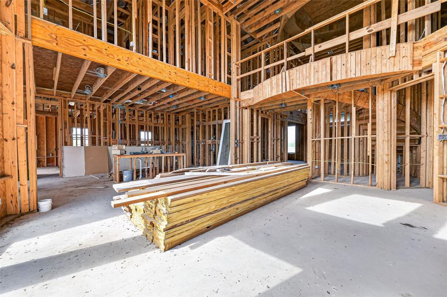 Open unfinished space showcasing framing and build progress.