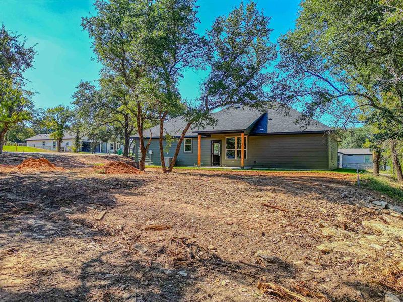 View of front of house with a shingled roof