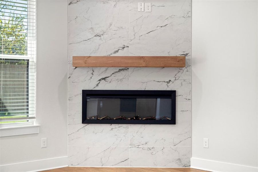 Detailed view of wood finished floors and a fireplace