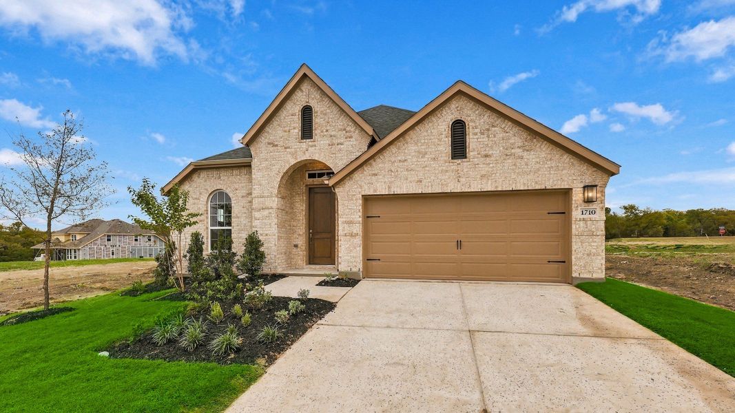 Front exterior of a new home in Thompson Farms, Van Alstyne, TX, highlighting curb appeal (Image 21). Front exterior of a new home in Thompson Farms, Van Alstyne, TX, highlighting curb appeal (Image 21).