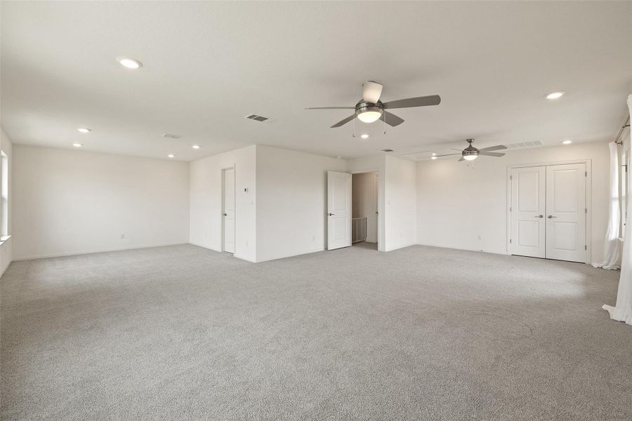 Empty room with light carpet, visible vents, recessed lighting, and a ceiling fan