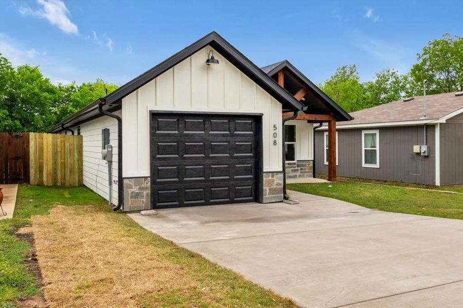 Modern farmhouse with a front yard and a garage