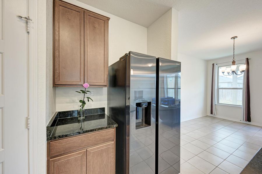 Granite counters and stainless steel appliances elevate this kitchen's functionality and visual appeal.