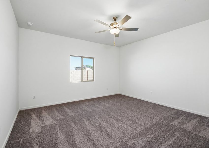 The master bedroom is beautifully lit by natural sunlight.