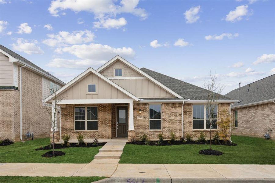 Craftsman inspired home with a front yard