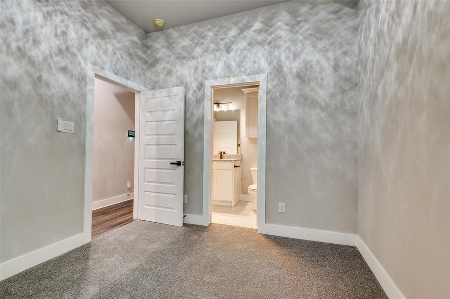 Unfurnished room featuring carpet flooring and a smoke detector Unfurnished room featuring carpet flooring and a smoke detector