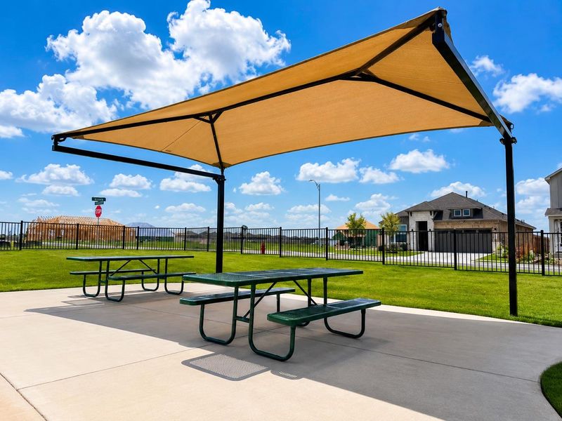 An inviting outdoor seating area offers respite from the sun, ideal for community gatherings.