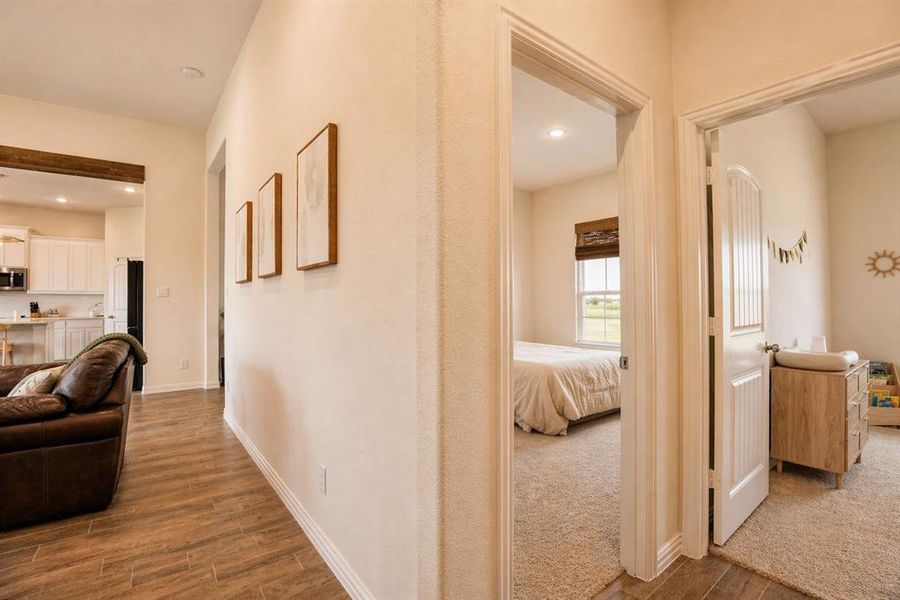 Hallway with wood-finish tile flooring and neutral wall tones