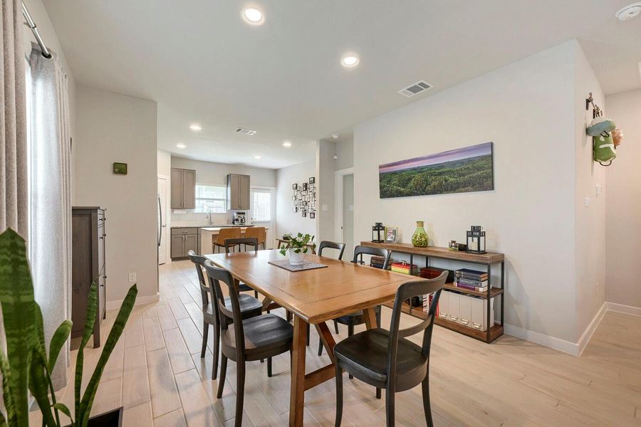 An open floorplan seamlessly connects the dining area to a well-appointed kitchen. An open floorplan seamlessly connects the dining area to a well-appointed kitchen.