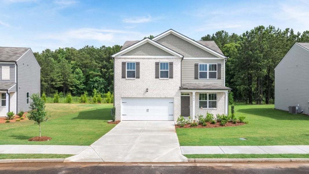 Front exterior of a new home in Oaks at Cedar Grove, Fairburn, GA, highlighting curb appeal (Image 2). Front exterior of a new home in Oaks at Cedar Grove, Fairburn, GA, highlighting curb appeal (Image 2).