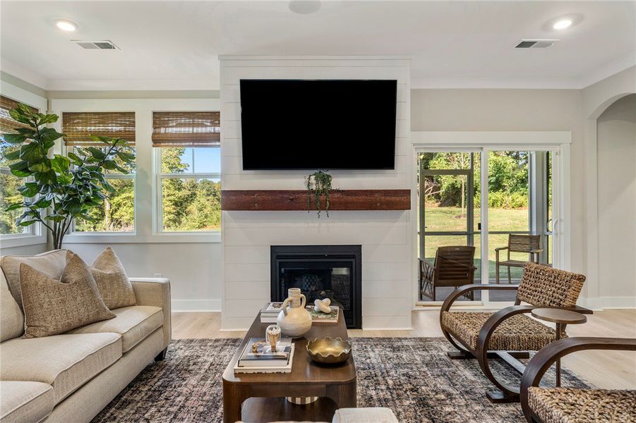 This bright living space features a cozy fireplace This bright living space features a cozy fireplace
