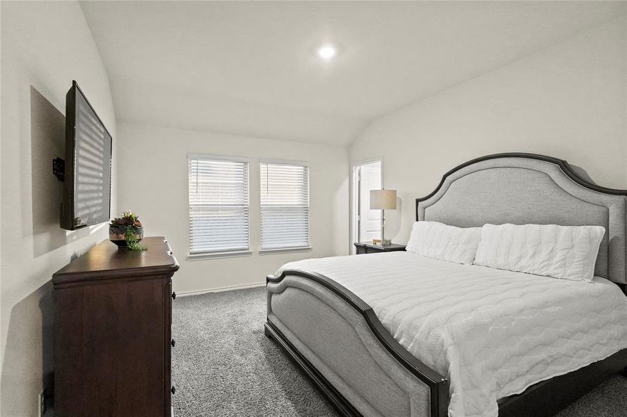 Large primary bedroom with high ceilings