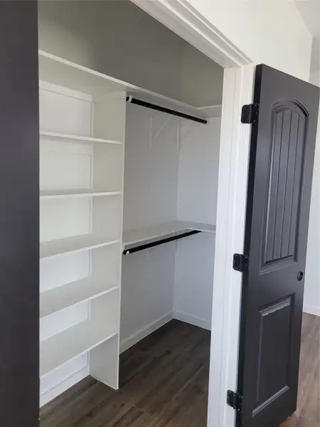 Custom-designed storage solutions create an orderly and accessible wardrobe space. Custom-designed storage solutions create an orderly and accessible wardrobe space.