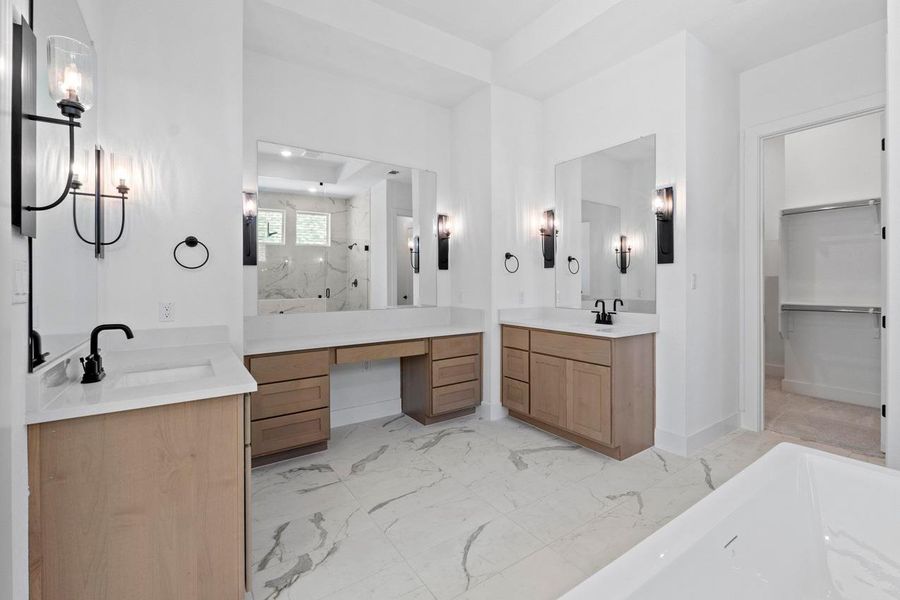 Full bathroom with two sinks, light marble finish flooring, a marble finish shower, vanity, and a bathtub Full bathroom with two sinks, light marble finish flooring, a marble finish shower, vanity, and a bathtub