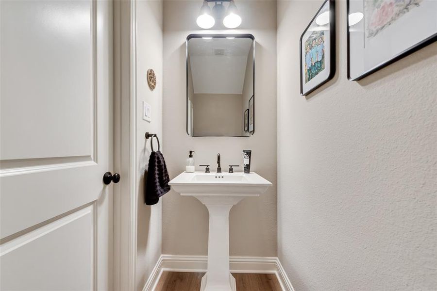 Bathroom featuring baseboards and wood finished floors