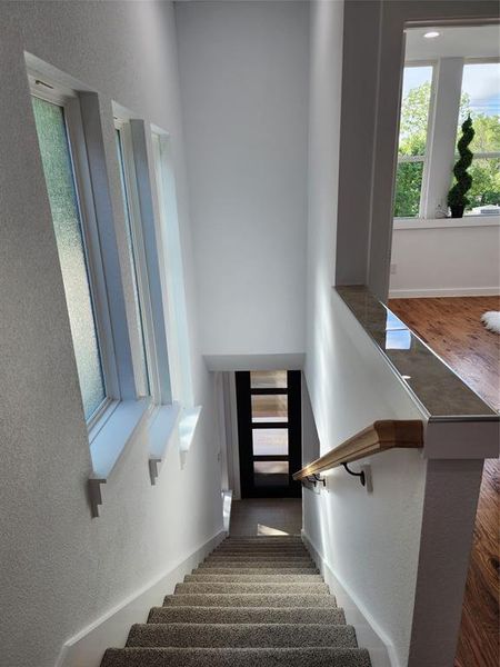 Stairs featuring hardwood / wood-style flooring