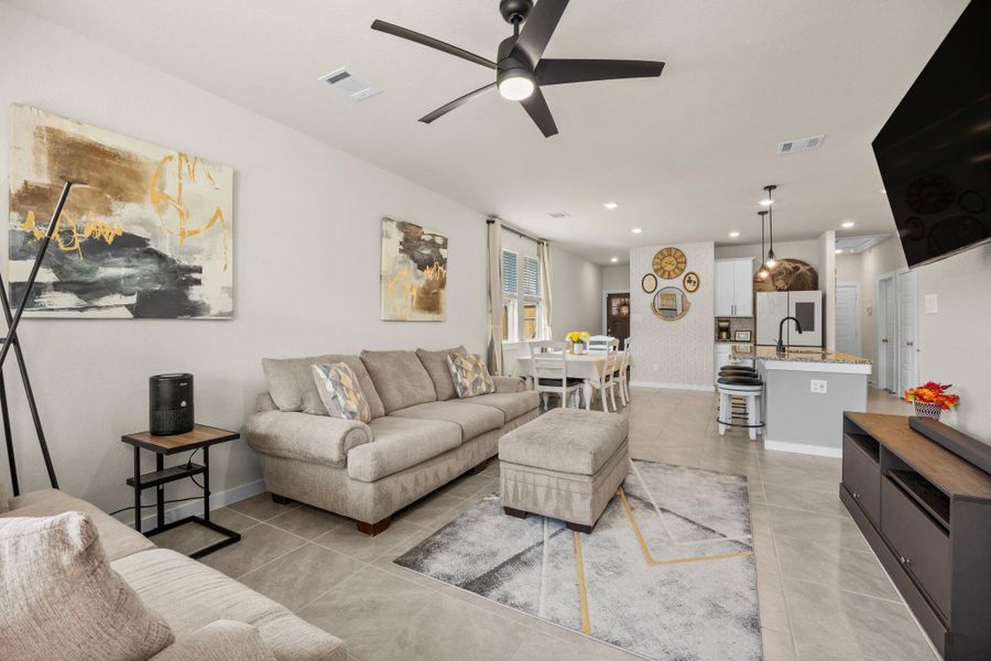 This bright and welcoming space connects the living room to the kitchen and dining area, making it perfect for both daily living and entertaining. The open layout ensures no one is left out of the conversation!