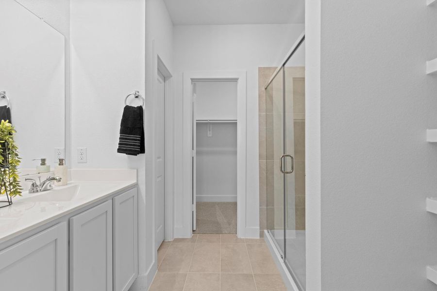 The spa-like primary bathroom showcases a dual-sink vanity with sleek cultured marble countertops, modern chrome fixtures, and ample cabinet storage—delivering both luxury and everyday functionality. **Image Representative of Plan Only and May Vary as Built**. The spa-like primary bathroom showcases a dual-sink vanity with sleek cultured marble countertops, modern chrome fixtures, and ample cabinet storage—delivering both luxury and everyday functionality. **Image Representative of Plan Only and May Vary as Built**.