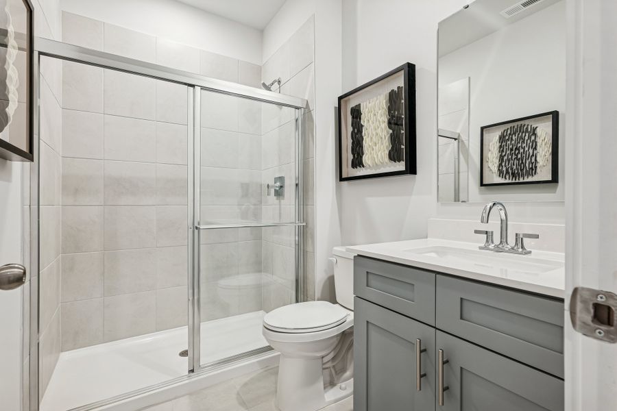 A bathroom with a glass shower. A bathroom with a glass shower.