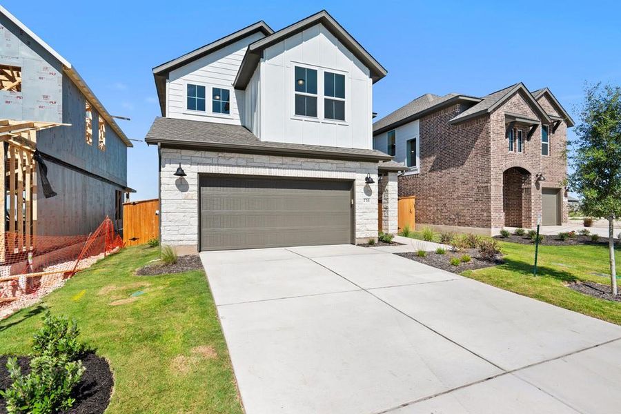 Front exterior of a new home in Terrace Collection at Lariat, Liberty Hill, TX, highlighting curb appeal (Image 21). Front exterior of a new home in Terrace Collection at Lariat, Liberty Hill, TX, highlighting curb appeal (Image 21).
