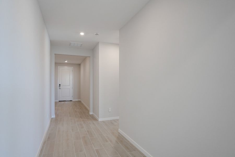 A hallway with white walls.
