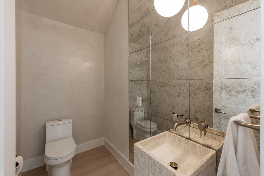 Antique mirror brings depth and character to the powder room, paired with full height designer tile, natural stone and warm metallic fixtures for an unexpected moment of drama. Antique mirror brings depth and character to the powder room, paired with full height designer tile, natural stone and warm metallic fixtures for an unexpected moment of drama.
