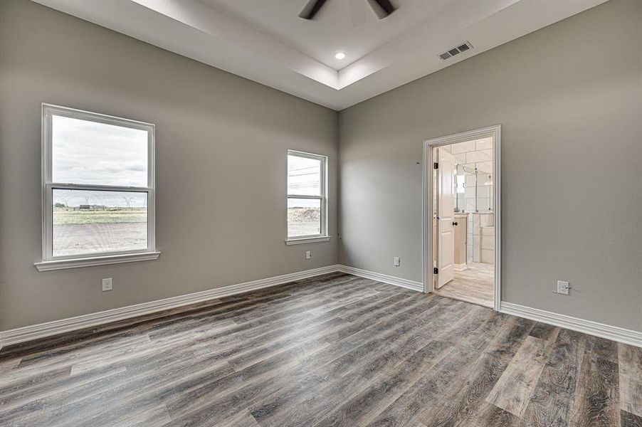 Empty room featuring hardwood / wood-style floors and ceiling fan