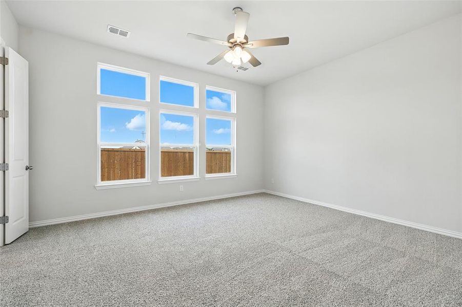 Spare room with ceiling fan and carpet floors
