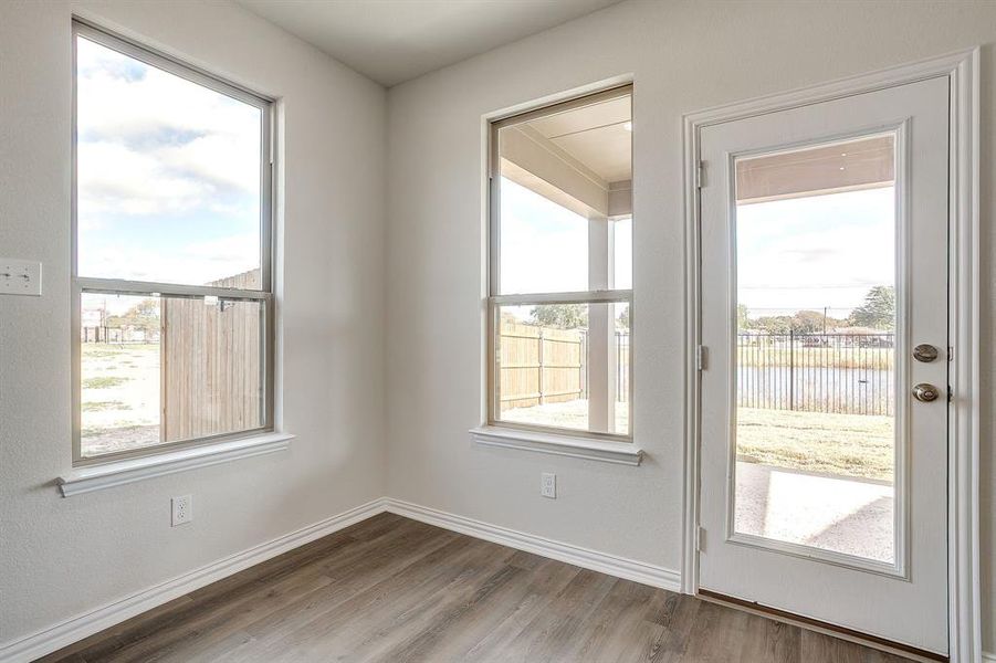 Doorway featuring wood finished floors and plenty of natural light