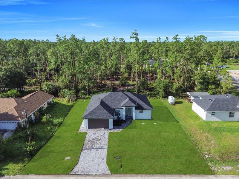 Front exterior of a new home in , Lehigh Acres, FL, highlighting curb appeal (Image 26).