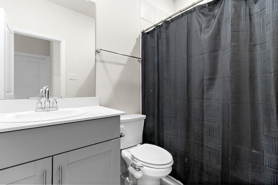 Bathroom featuring vanity and curtained shower Bathroom featuring vanity and curtained shower