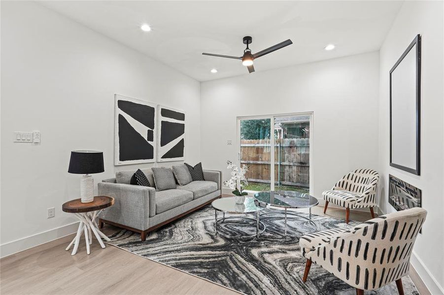 Living room featuring hardwood / wood-style flooring and ceiling fan