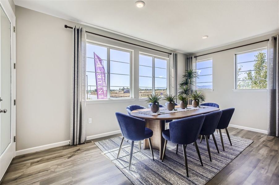 A dining room with a table and chairs. A dining room with a table and chairs.