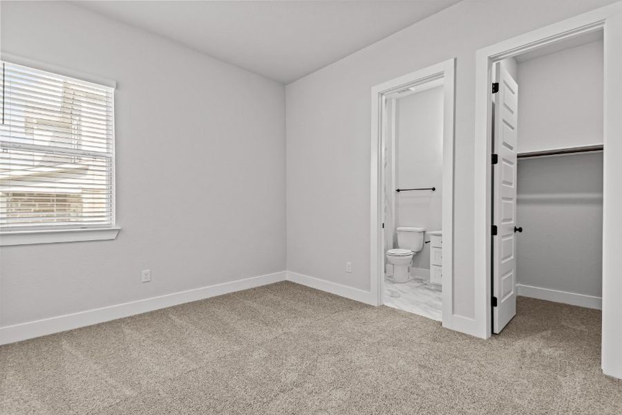 A bathroom with a toilet and a sink.