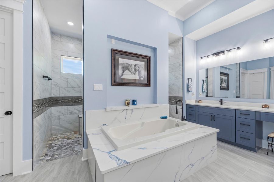 Luxurious soaking tub framed by elegant marble-inspired surfaces, creating a tranquil setting for relaxation and rejuvenation.