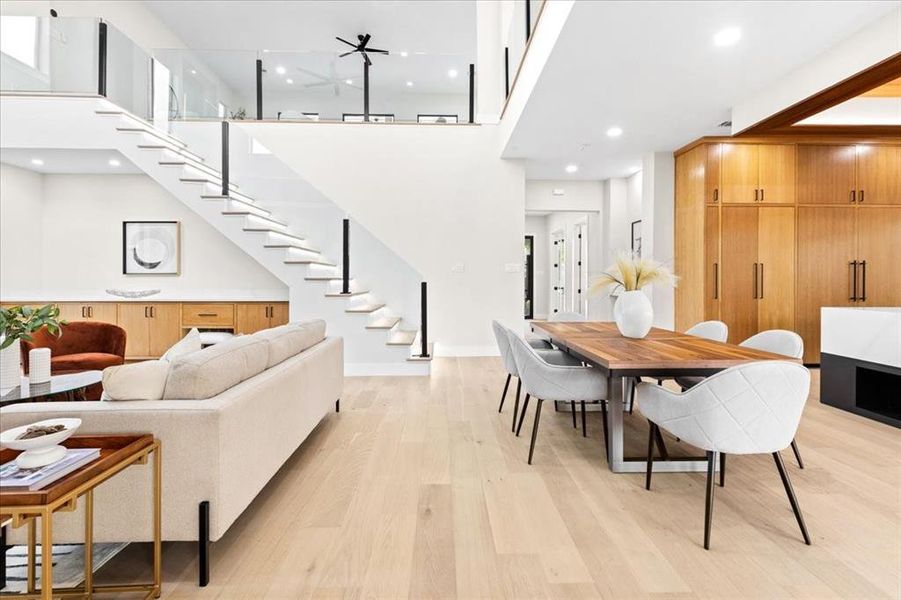 Living room featuring light hardwood / wood-style flooring and a towering ceiling