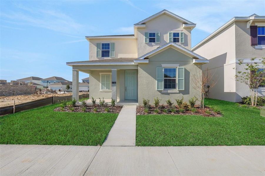 Front exterior of a new home in Crossroads at Kelly Park, Apopka, FL, highlighting curb appeal (Image 24).
