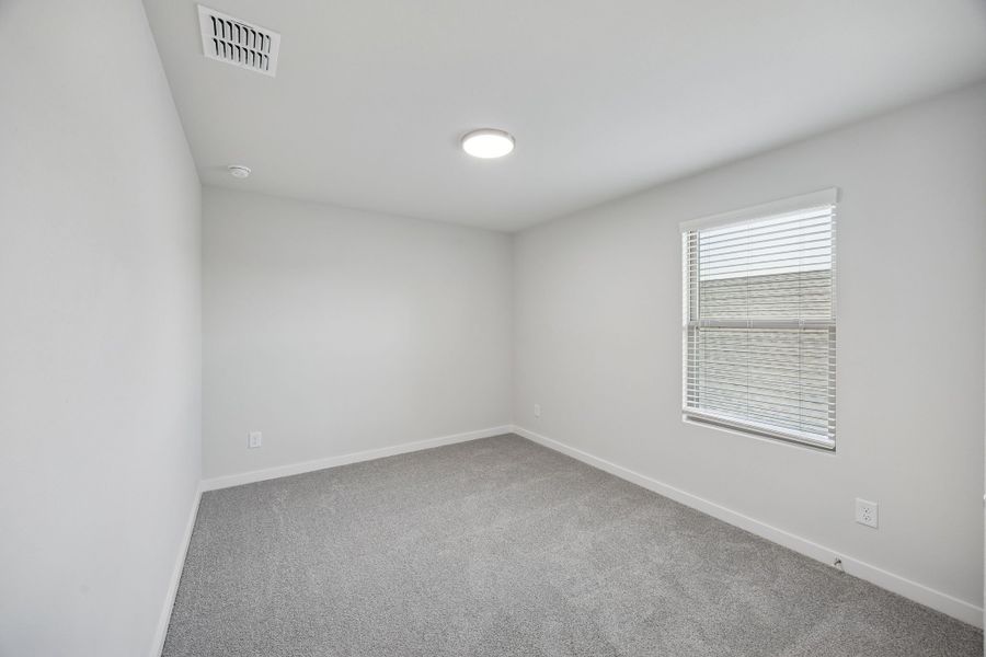 Bedroom in the Oak II home plan by Trophy Signature Homes – REPRESENTATIVE PHOTO