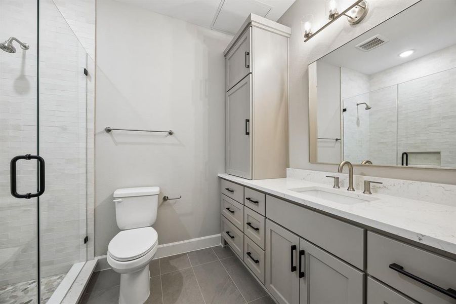 Full bathroom featuring vanity, a shower stall, and light tile patterned floors Full bathroom featuring vanity, a shower stall, and light tile patterned floors